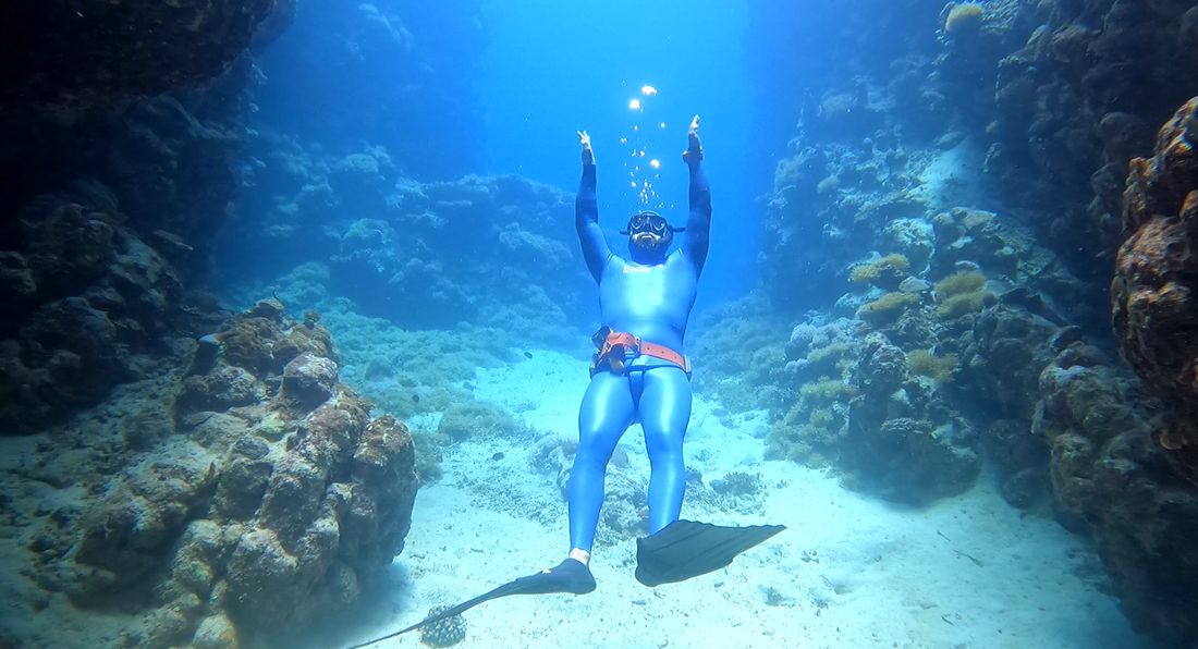 Freediver over the reef at Ras Mohamed