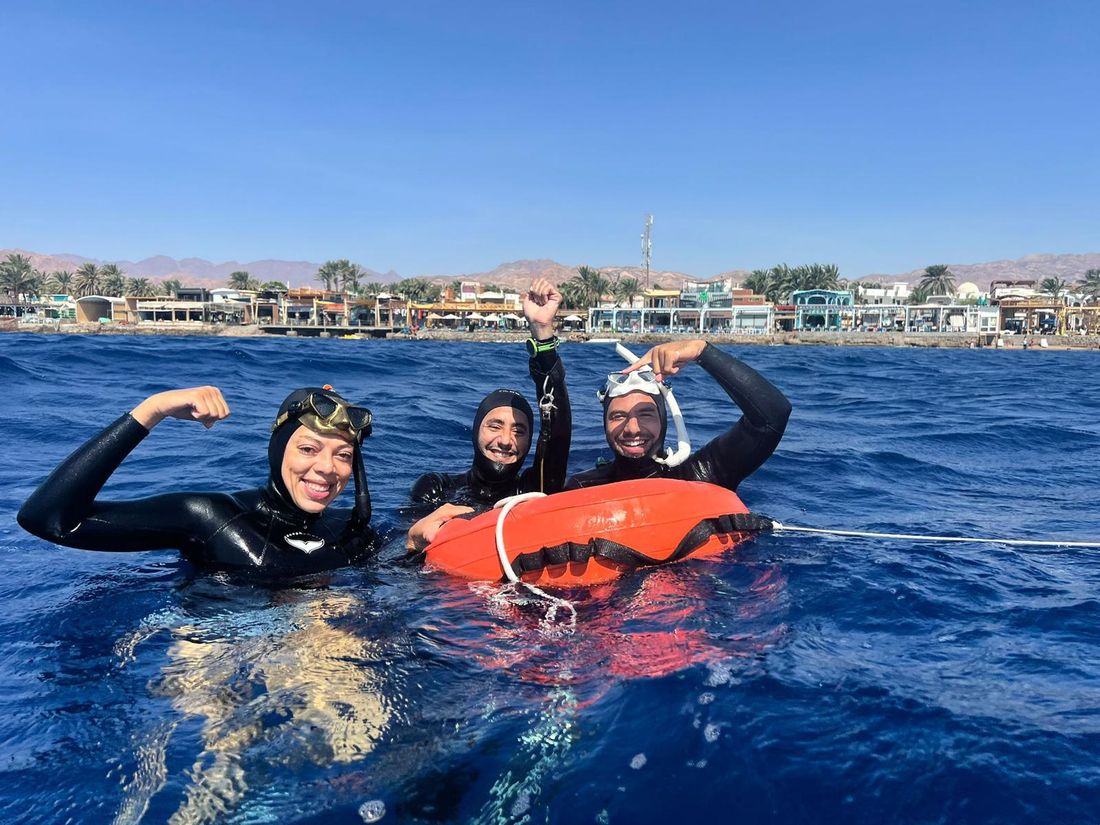 Rimi with students in the water