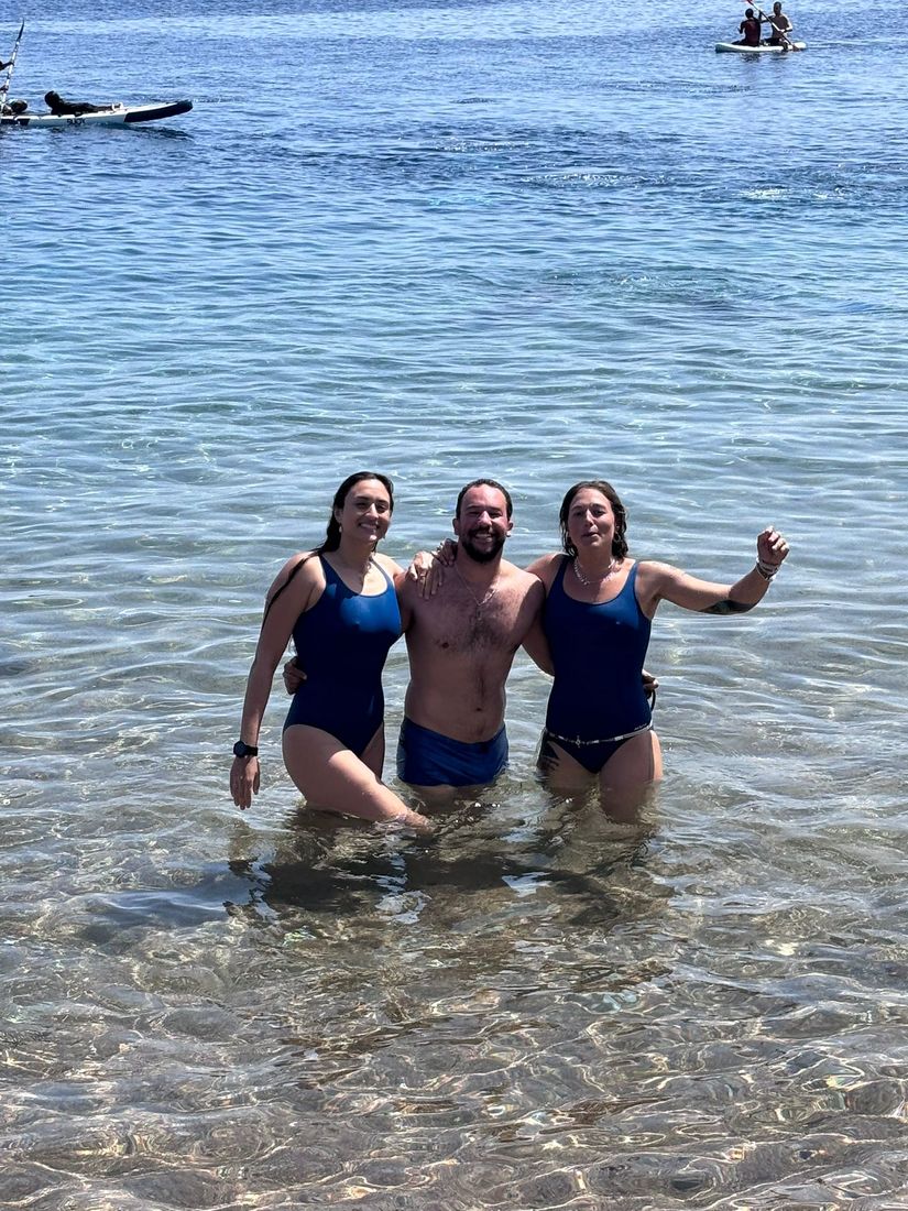 Three freedivers smiling in the water