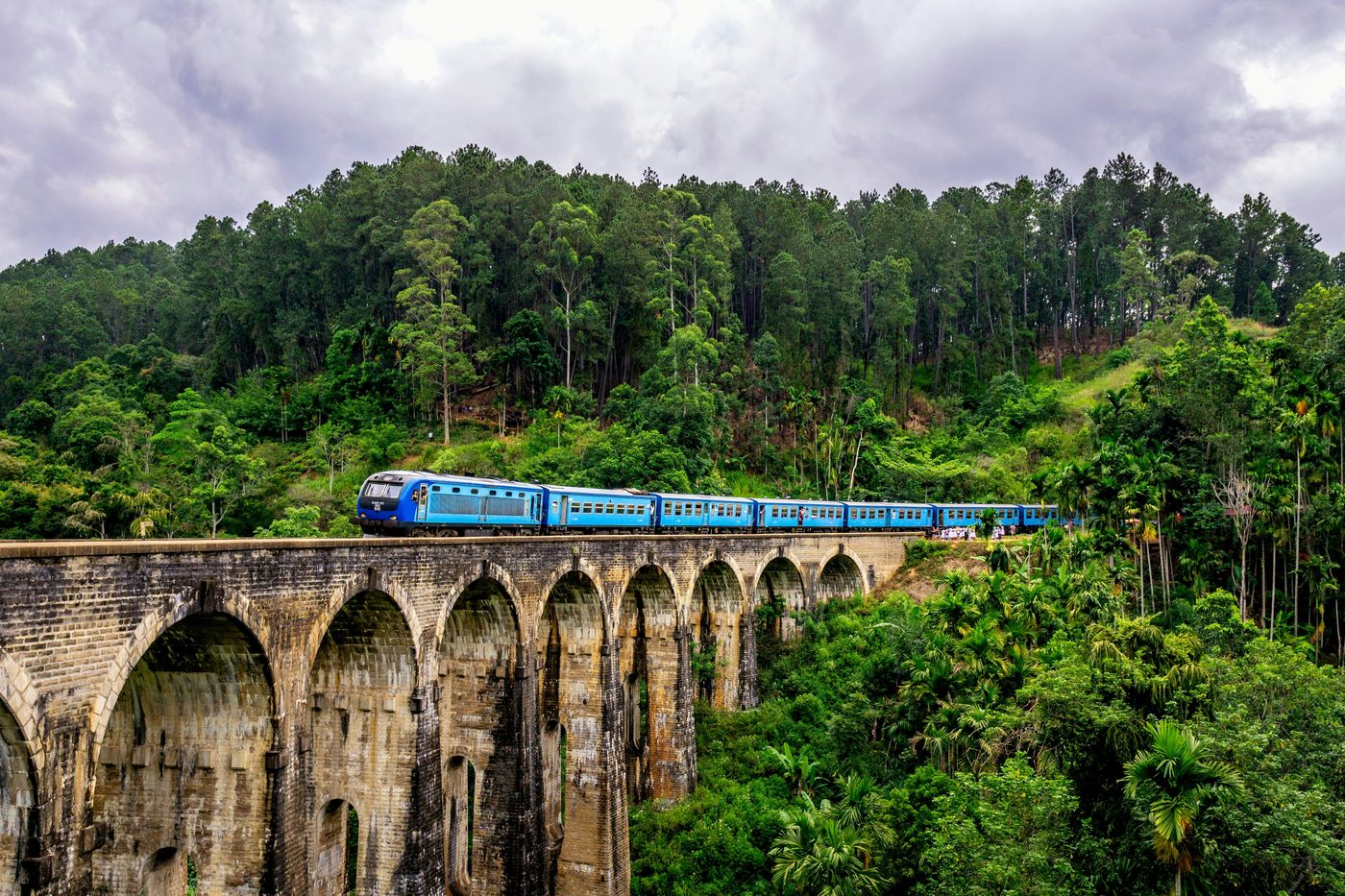 The blue hill-country train crossing the Nine Arch Bridge at Ella, Sri Lanka