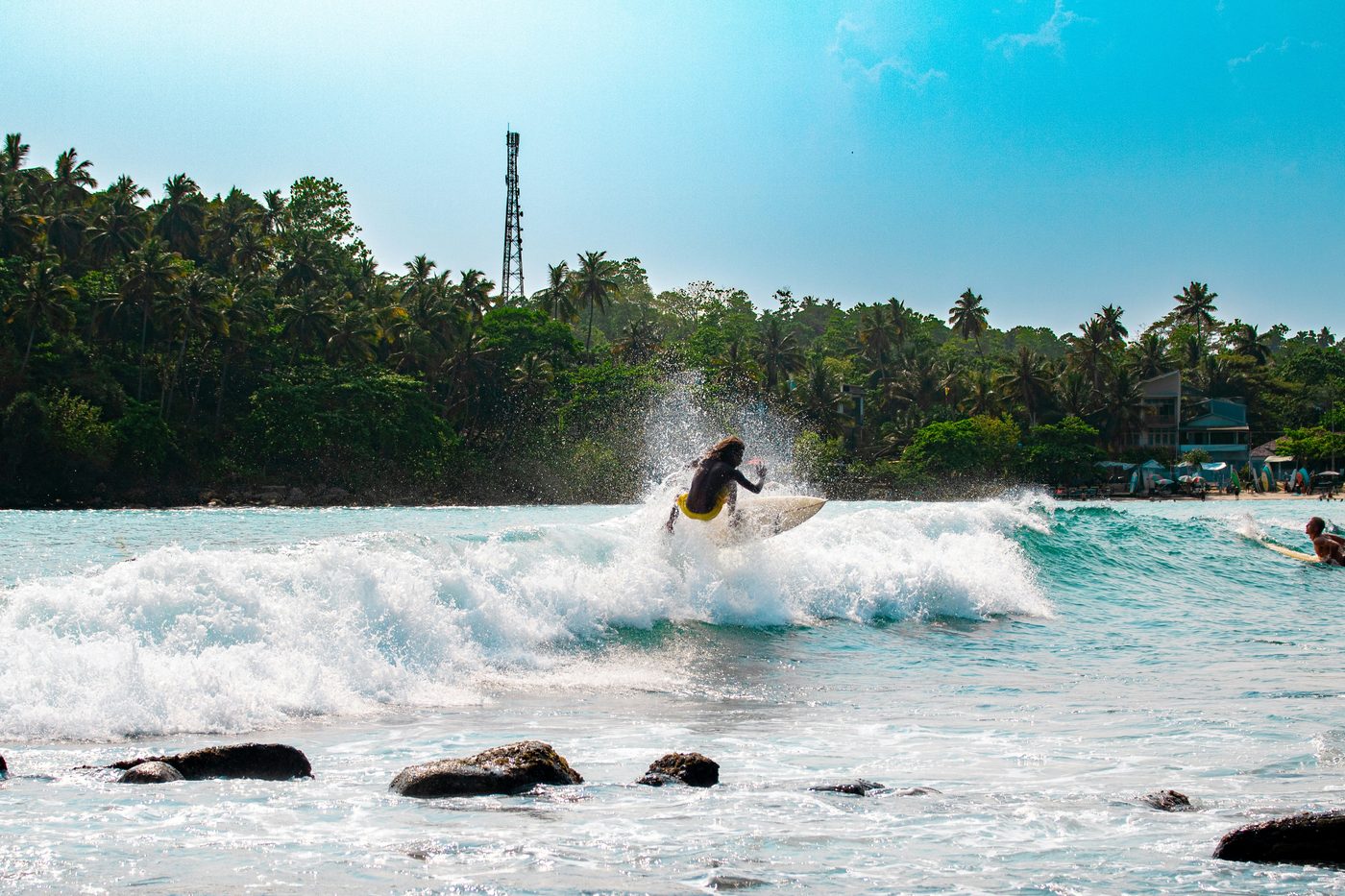 A surfer riding a wave off the south coast of Sri Lanka
